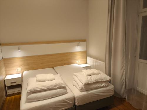 a bedroom with a bed with two pillows on it at Sienkiewicza Centrum in Kielce