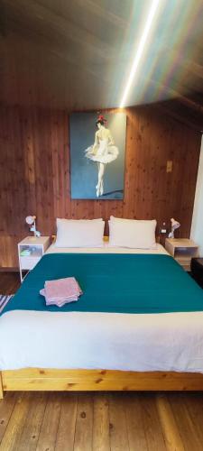a bedroom with a large bed with a picture of a ballet dancer at La Casetta 23 in Perledo