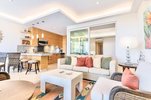 a living room with a couch and a table at ANANA El Dorado 203 | Condo with Lake views & Pool in Ajijic