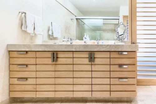 a bathroom with a sink and a mirror at ANANA El Dorado 203 | Condo with Lake views & Pool in Ajijic