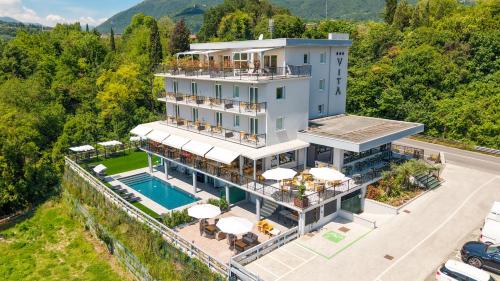 an aerial view of a building with a pool at Hotel Vita in Salò
