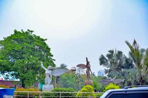 two statues of women with umbrellas in a park at Holiday Inn Express Greater Noida Knowledge Park by IHG in Greater Noida