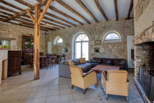 a living room with a couch and a table at La Petite Cour in Mayac