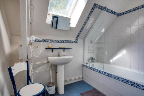 a bathroom with a sink and a toilet and a tub at La Petite Cour in Mayac