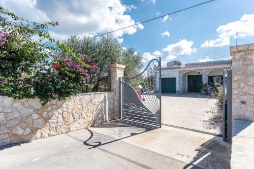ein Tor zu einem Haus mit einer Steinmauer in der Unterkunft Villetta Marika - Salento Reservation in Marina di Mancaversa