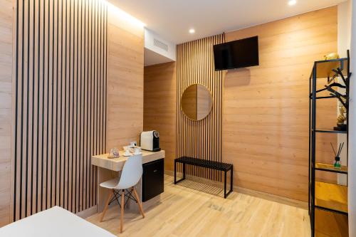 a room with wooden walls and a desk and a television at Al Primo Vico in Matera
