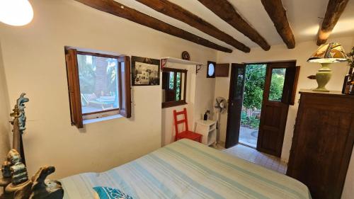 a bedroom with a bed and a window and a door at La Casa di Nonna Ida in Stromboli