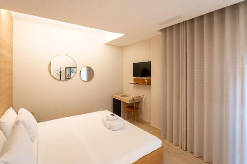 a bedroom with a white bed and a window at Al Primo Vico in Matera