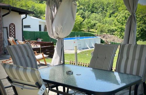 a table and chairs with a view of a pool at Avala Sunset Apartments in Belgrade