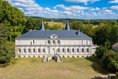 an aerial view of a large white building on a field at L'Aile Est in Mayac