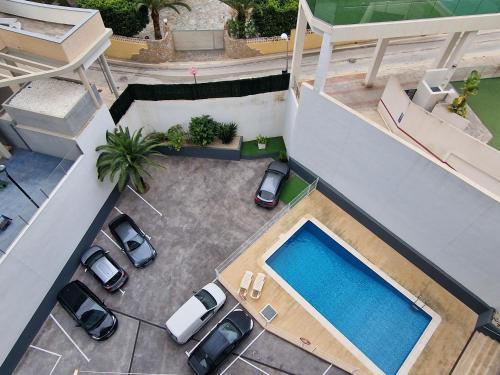 an overhead view of a swimming pool in a yard with parked cars at Luxuery View in Calpe
