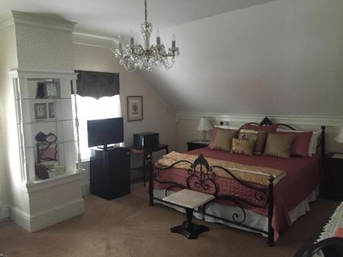 a bedroom with a bed and a chandelier at Victoria Inn in Hampton