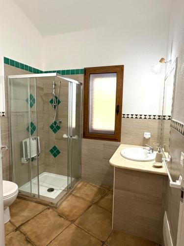 a bathroom with a shower and a toilet and a sink at Orosei Summer Holidays - Cala del Turco green house in Orosei