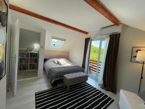a bedroom with a bed and a balcony at Avala Sunset Apartments in Belgrade