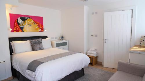 a bedroom with a large bed and a chair at Bayview Bed and Breakfast in Stonehaven