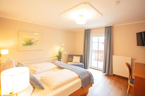 a hotel room with a bed and a window at Seewirt in Zell am Moos