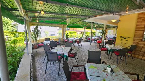 an outdoor patio with tables and chairs and tablesearcher at Gästehaus Bärwald in Seeboden
