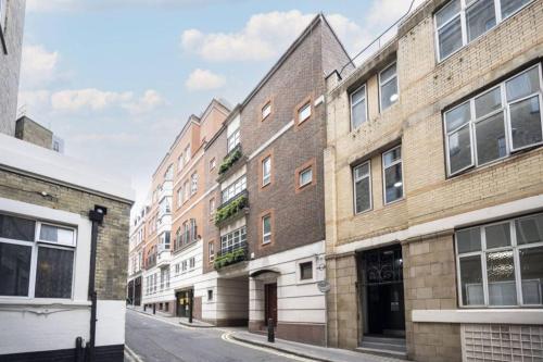a row of brick buildings on a street at CARLTON COURT - MAYFAIR in London