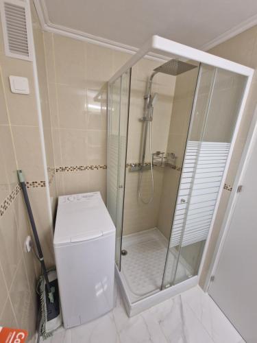 a bathroom with a shower and a washer and dryer at Luxuery View in Calpe