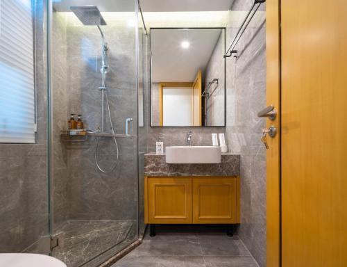 a bathroom with a sink and a shower at 三亚亮庭观棠独享别墅 in Sanya