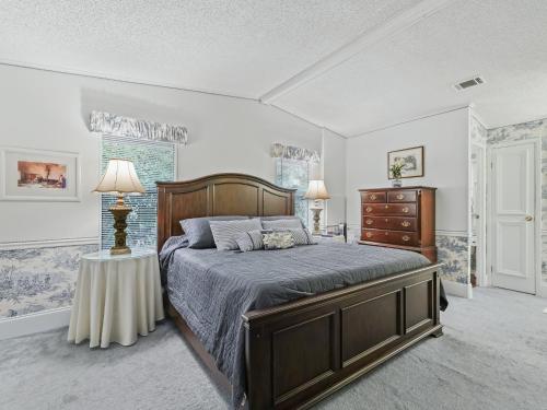 a bedroom with a bed and a dresser at 1705 Z1 Village of Orange Blossom Gardens by REMAX Premier in The Villages