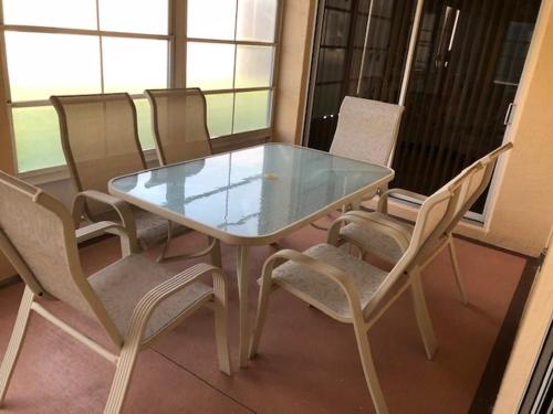 a glass table and chairs in a room at 1506 Z2b VILLAGE OF SANTO DOMINGO by REMAX Premier in The Villages