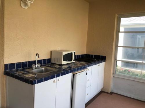 a kitchen with a sink and a microwave on a counter at 1506 Z2b VILLAGE OF SANTO DOMINGO by REMAX Premier in The Villages