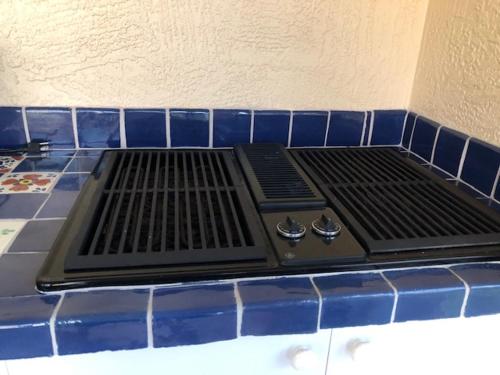 a stove top on top of a blue tiled counter at 1506 Z2b VILLAGE OF SANTO DOMINGO by REMAX Premier in The Villages