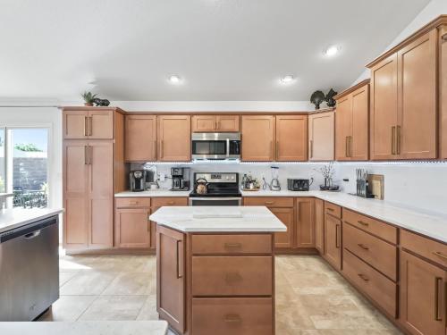 a kitchen with wooden cabinets and white counter tops at 16837 Z2b Village of Woodbury by REMAX Premier in The Villages