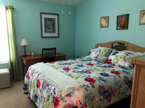 a bedroom with a bed and a desk at 2383 Z3a VILLAGE OF TAMARIND GROVE by REMAX Premier in The Villages