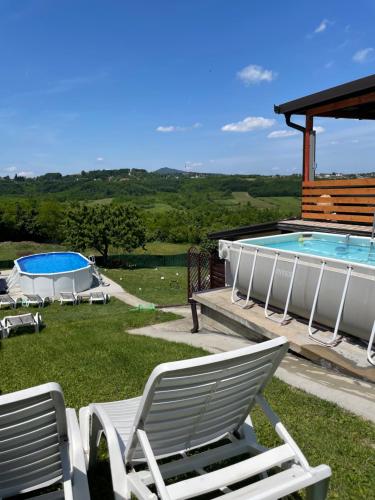 a group of lawn chairs sitting next to a swimming pool at Avala Sunset Apartments in Belgrade
