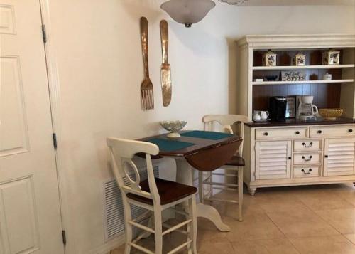 a kitchen with a table and chairs in a room at 2474 Z3a VILLAGE OF ST JAMES by REMAX Premier in The Villages