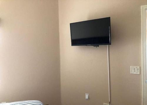 a flat screen tv hanging on a wall at 2474 Z3a VILLAGE OF ST JAMES by REMAX Premier in The Villages