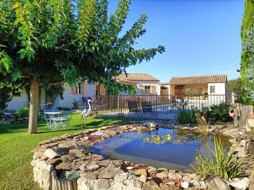 a pond in the backyard of a home at Le faré tchanqué chambre d'hôtes, parking gratuit sur place in Cavaillon