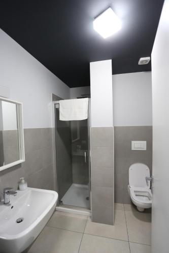a bathroom with a shower and a sink and a toilet at New Ulivo Apartment 2 in Seriate