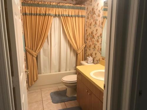 a bathroom with a toilet and a sink and a window at 748A Z2b VILLAGE OF DE LA VISTA by REMAX Premier in The Villages