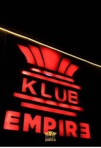 a sign for a klue empire in red at Belmorris Hotel Ltd in Mama
