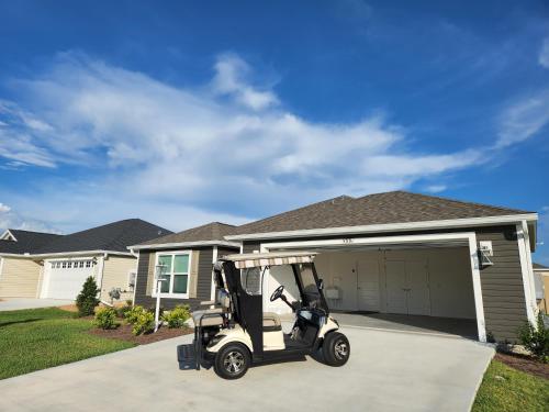 a golf cart parked in front of a house at 3 Bedroom 2 Bath Designer in The Villages