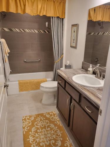 a bathroom with a sink and a toilet and a tub at 5991 Z5 VILLAGE OF ST. CATHERINE by REMAX Premier in The Villages