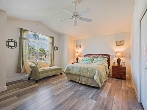 a bedroom with a bed and a chair and a window at 786 Z3a VILLAGE OF HEMINGWAY by REMAX Premier in The Villages