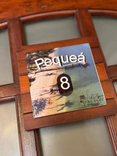 a board game with a dice on top of it at Vila Pequeá Pousada Ilhabela in Ilhabela