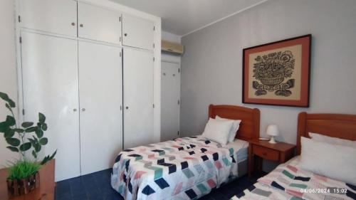 a bedroom with a bed and a dresser at Casa Alberto in Portimão