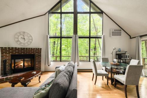 a living room with a couch and a fireplace at Cozy A-Frame w Fireplace Fire Pit Grill & WiFi in Hedgesville