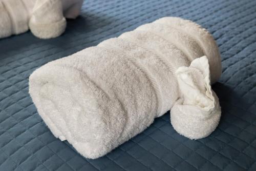 a white towel on top of a bed at Cozy A-Frame w Fireplace Fire Pit Grill & WiFi in Hedgesville