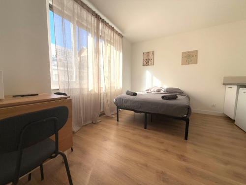 une chambre avec un lit et une grande fenêtre dans l'établissement M28 Marquer joli appartement proche de la gare et du centre ville, à Annemasse