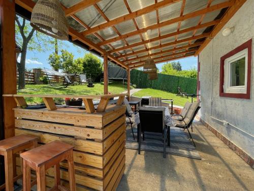 a patio with a wooden pergola and a table and chairs at Avala Sunset Apartments in Belgrade