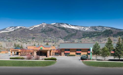a large building with mountains in the background at Holiday Inn Steamboat Springs by IHG in Steamboat Springs