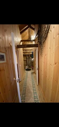 an empty hallway in a building with wooden walls at Rorbu Vestersia i Skjelfjord in Ramberg