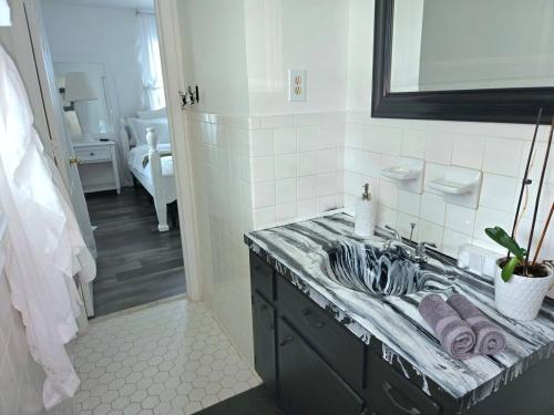 a bathroom with a sink and a mirror at Magnolia Farmhouse at Summerfield NC in Summerfield