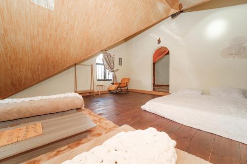 a large room with two beds and a table at Ngân Villa in Xuan An
